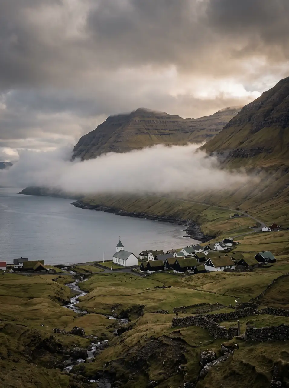 Cloud in the valley behind the village